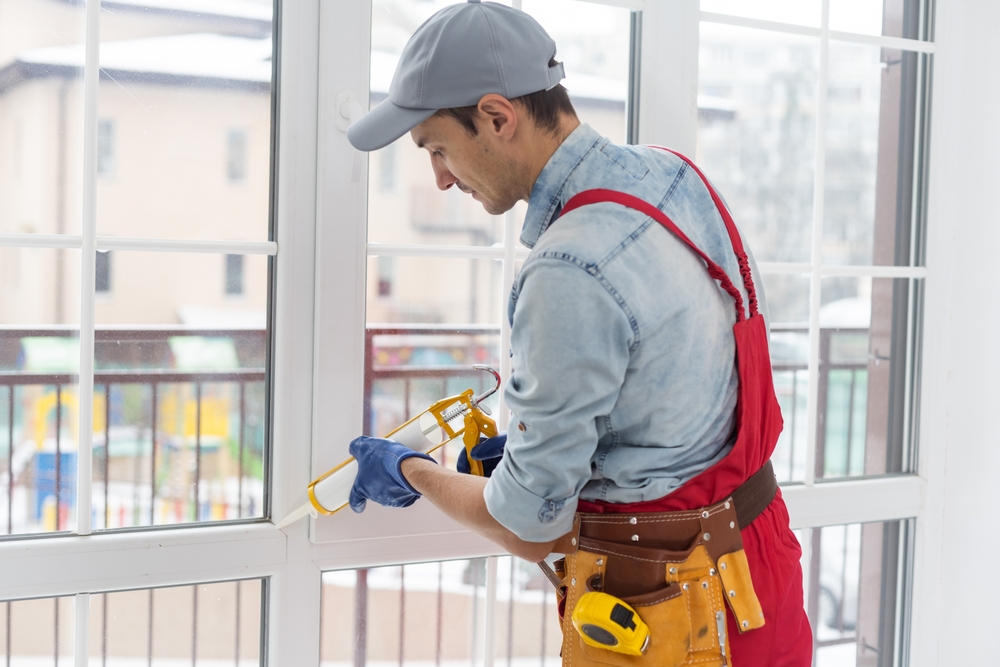 Professional performing window maintenance services on residential home windows