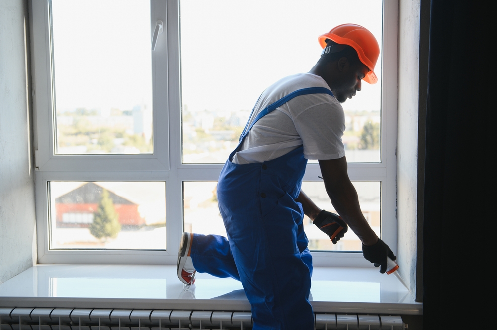 Professional installing a modern sliding glass door in a residential home patio entrance