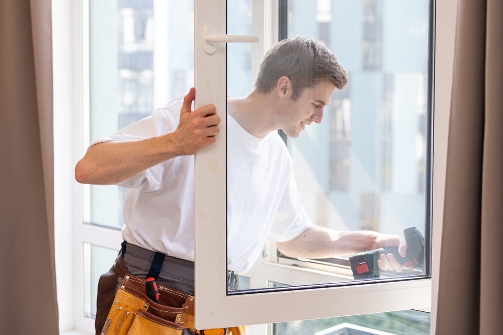 Technician performing professional glass installation to improve home energy efficiency