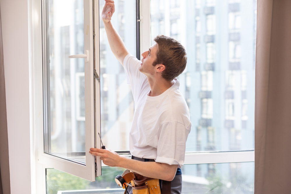 Professional window technicians inspecting residential windows for hidden issues and damage
