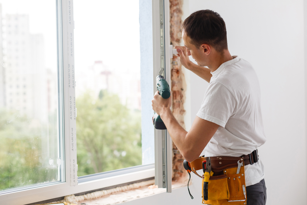 Professional replacing damaged glass during an entry door glass replacement