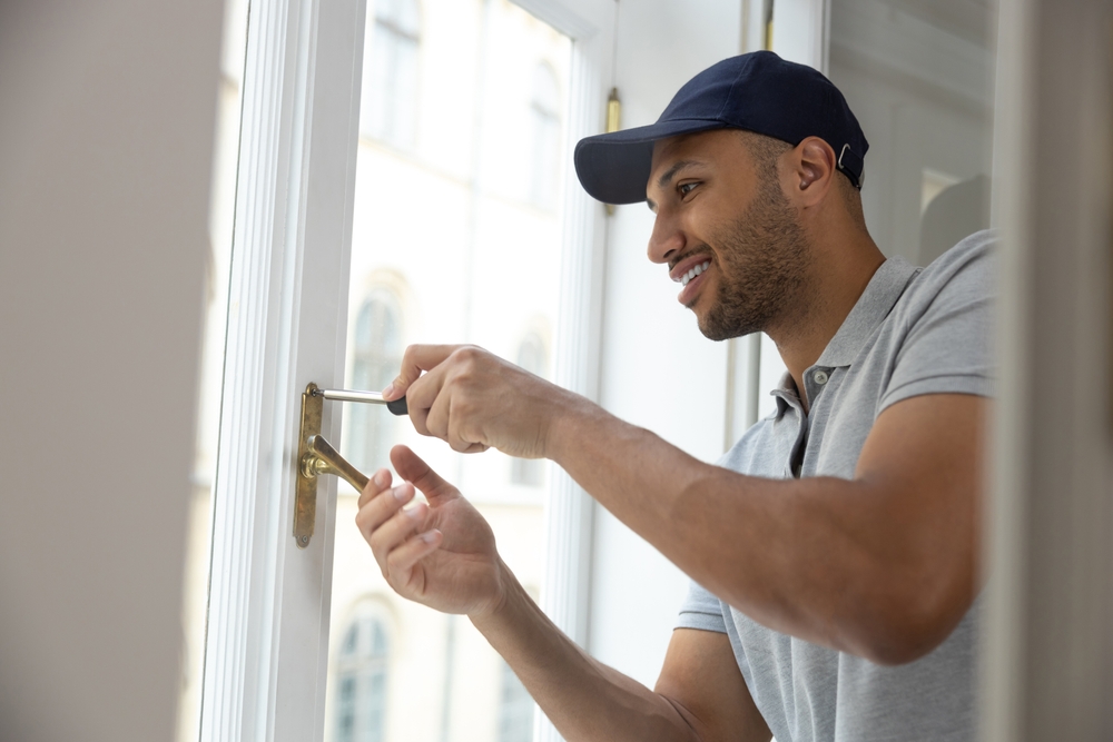 Window repair technician inspecting a failed window seal for damage and moisture